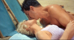 Doris Day and Rock Hudson kiss on the beach during a romantic moment in Lover Come Back.